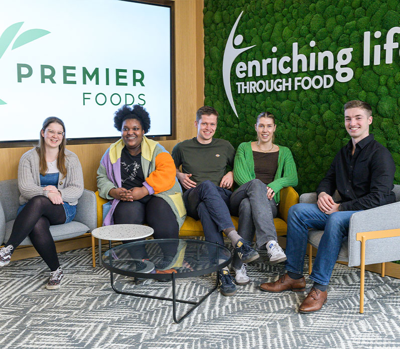 Group of people with logos in background