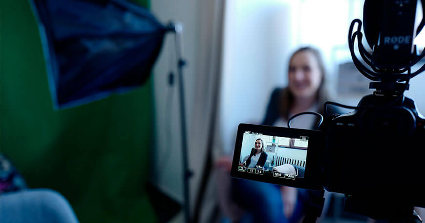 Person talking in front of a video camera