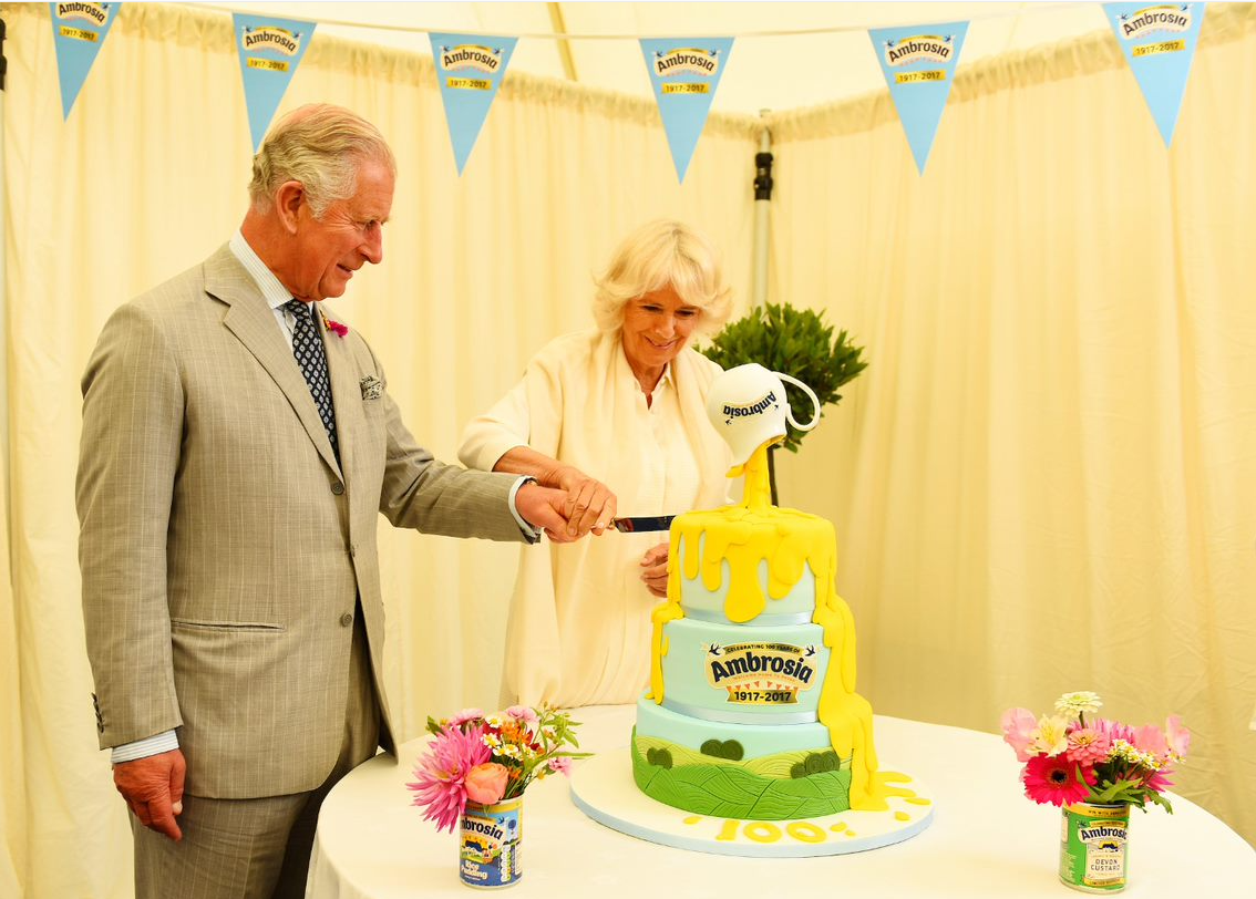 King Charles and Queen Camilla cutting Ambrosia cake